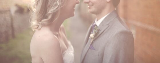 Soft, romantic portrait of Sarah and Peter on their wedding day in Oxfordshire, England, with pastel light and a gentle documentary wedding videography feel.