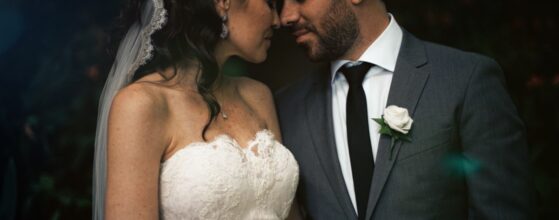 American bride Trisha in white lace wedding dress and Portuguese groom Luis from Madeira in dark suit share an intimate emotional moment during their destination wedding in Madeira, Portugal